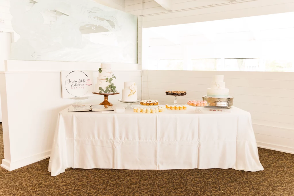 The Watertable Event Space Incredible Edibles Bakery Table with Wedding Cake and Desserts